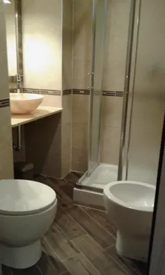 a bathroom with a toilet and a shower and a sink at IL Sole in Rome