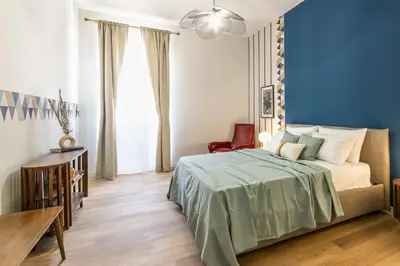 a bedroom with a bed and a table and a chair at Collection39 Scipioni Luxury Apartment in Rome