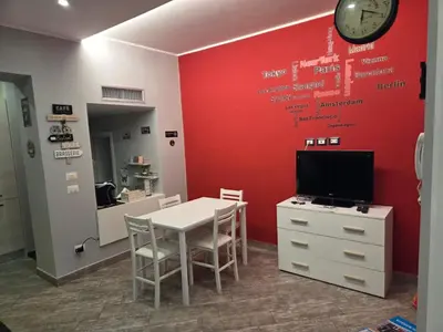 a room with a table and a clock on a wall at Barbara House Monteverde in Rome
