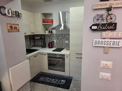 a kitchen with white cabinets and a stove top oven at Barbara House Monteverde in Rome