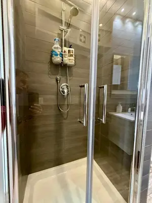a shower with a glass door in a bathroom at LaReginetta in Rome