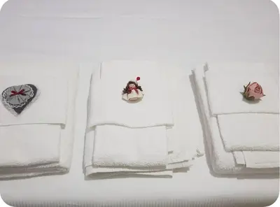 a group of white towels with a toy on them at LaReginetta in Rome