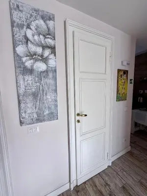 a white door in a room with a painting on the wall at LaReginetta in Rome