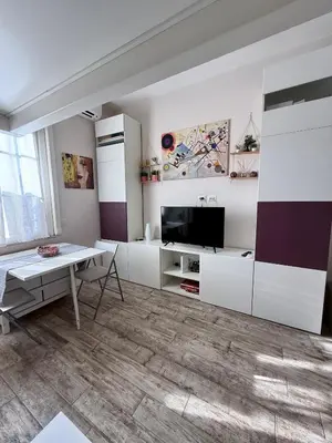 a living room with white cabinets and a table at LaReginetta in Rome