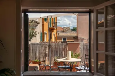 a view of a table and chairs from a window at Casa Mia - Trastevere Rooftop Nest in Rome