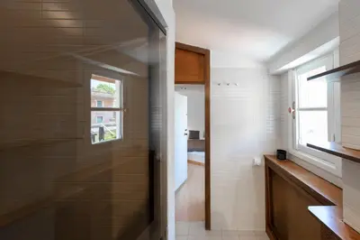 a bathroom with a shower with a glass door at Casa Mia - Trastevere Rooftop Nest in Rome