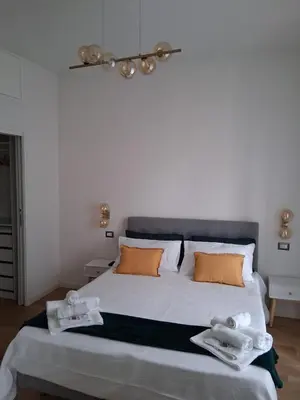 a bedroom with a large bed with two towels on it at Golden Suite in Rome