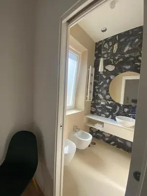 a bathroom with two sinks and a mirror at Golden Suite in Rome