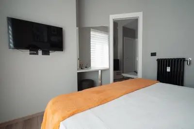 a bedroom with a bed and a flat screen tv at La Perla dell'Appia in Rome