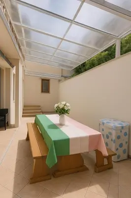 a room with a table with a vase of flowers on it at Colosseo Rooms Apartments in Rome