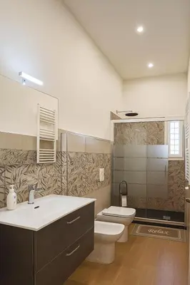a bathroom with a toilet and a sink at Colosseo Rooms Apartments in Rome