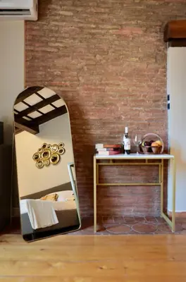 a dressing table with a mirror next to a wall at Biscione Dream Campo de'Fiori in Rome