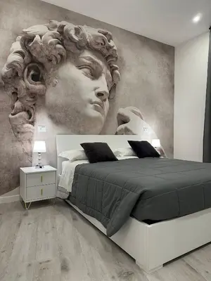 a bedroom with a large mural of a woman at Lux Urbis Pio VIII in Rome