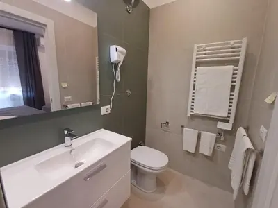 a bathroom with a sink and a toilet and a mirror at Lux Urbis Pio VIII in Rome
