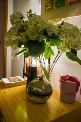 a vase of flowers sitting on a wooden table at PP Stanza Privata in Appartamento Pigneto in Rome