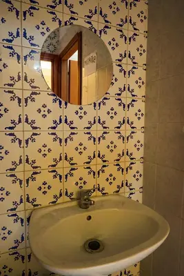 a bathroom with a sink and a mirror at PP Stanza Privata in Appartamento Pigneto in Rome