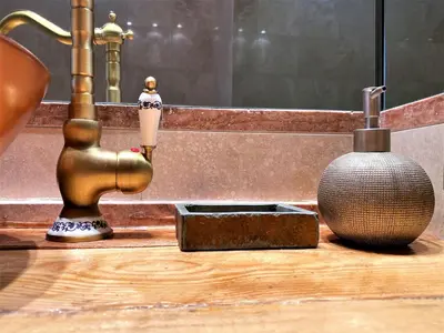 a bathroom sink with a faucet and a vase at Argilla Apartment in Rome