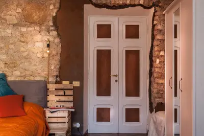 a bedroom with a bed and a white door at Argilla Apartment in Rome