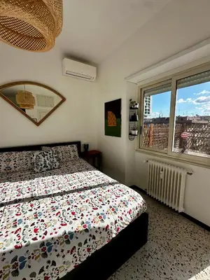 a bedroom with a bed and a window at Ai Parrocchetti, Loft con Terrazza Panoramica in Rome