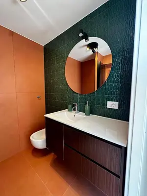 a bathroom with a sink and a mirror and a toilet at Ai Parrocchetti, Loft con Terrazza Panoramica in Rome