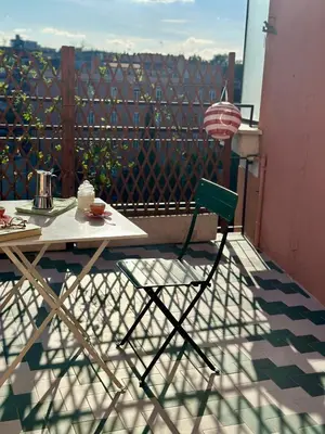 a table and a chair on a balcony at Ai Parrocchetti, Loft con Terrazza Panoramica in Rome