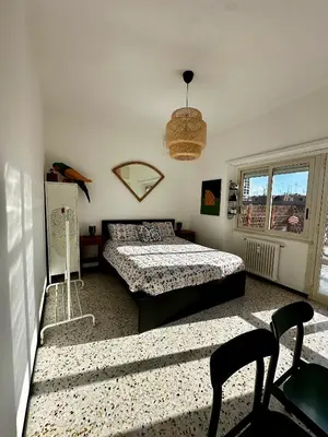 a bedroom with two beds and a window at Ai Parrocchetti, Loft con Terrazza Panoramica in Rome