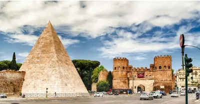 a large castle with a pyramid in front of it at Charme Holidays San Saba in Rome