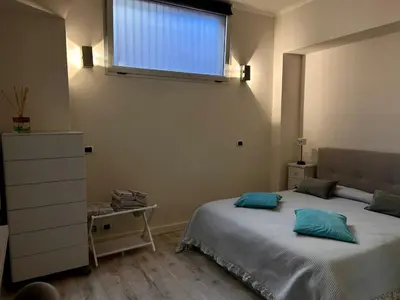 a bedroom with a bed and a dresser and a window at Charme Holidays San Saba in Rome