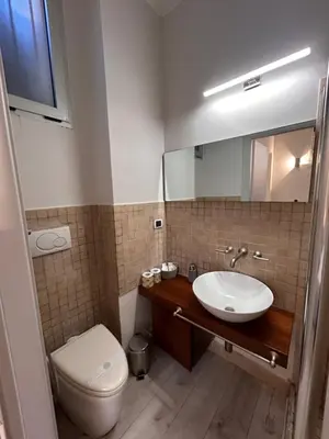 a bathroom with a sink and a toilet and a mirror at Charme Holidays San Saba in Rome