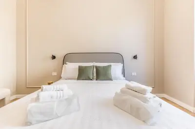 a white bed with two white towels on it at APT ROME - Guest House Casini 6 Trastevere in Rome