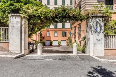 an entrance to a building with two concrete pillars at APT ROME - Guest House Casini 6 Trastevere in Rome