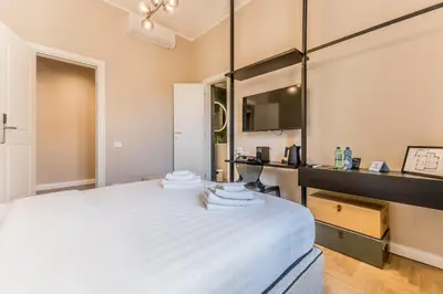 a bedroom with a large white bed and a mirror at APT ROME - Guest House Casini 6 Trastevere in Rome