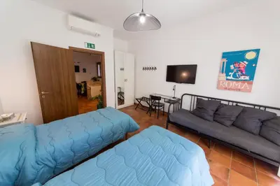 a living room with a blue couch and a table at wonderful apartment in Rome