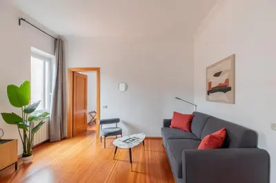 a living room with a couch and a chair at iFlat Spanish Steps Chic & Warming Hideaway in Rome