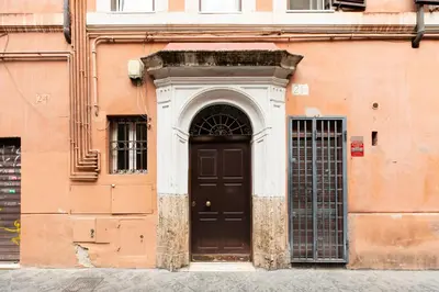 a building with a black door on the side of it at iFlat Spanish Steps Chic & Warming Hideaway in Rome