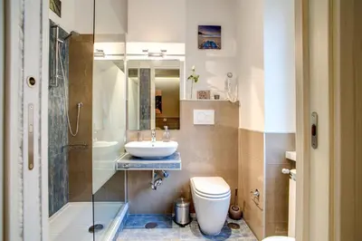 a bathroom with a sink and a toilet and a shower at Vatican Rooms Cipro in Rome