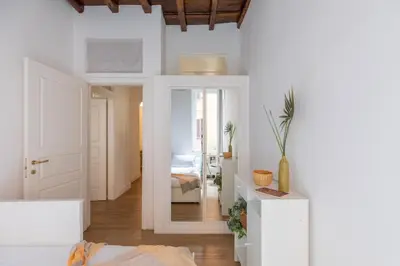 a room with a hallway with a bed and a mirror at iFlat Monti Charming & Cozy Apt by the Colosseum in Rome