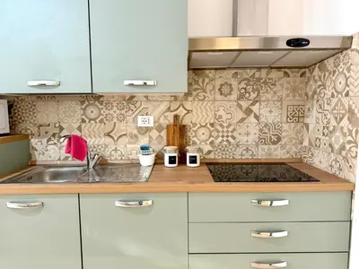 a kitchen with white cabinets and a sink at Domus Basilica San Paolo in Rome