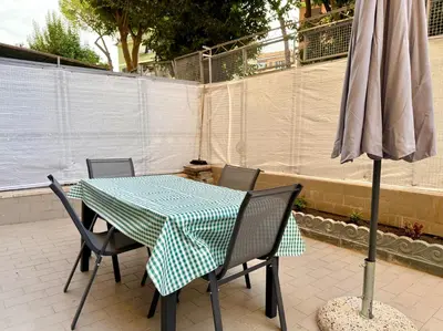 a table and chairs and an umbrella on a patio at Domus Basilica San Paolo in Rome