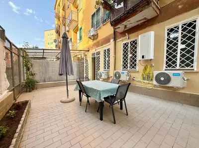 a patio with an umbrella and a table and chairs at Domus Basilica San Paolo in Rome