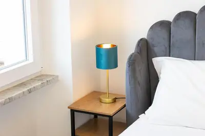a lamp on a table next to a bed at Vatican Secret Apartment in Rome