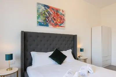 a bedroom with a bed and a painting on the wall at Vatican Secret Apartment in Rome
