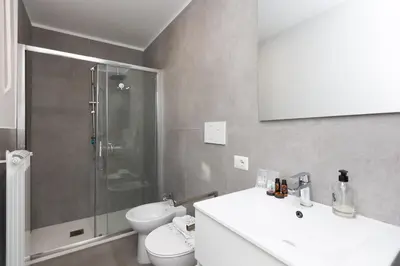 a bathroom with a toilet and a sink and a shower at Vatican Secret Apartment in Rome