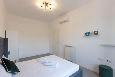 a bedroom with a bed with towels on it at Vatican Secret Apartment in Rome