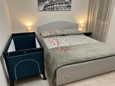 a bedroom with a bed with red roses on it at Vatican Stay Ottaviano in Rome