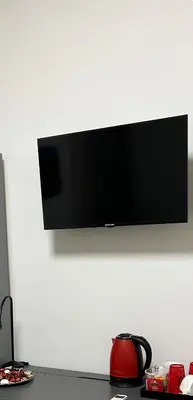 a flat screen tv hanging on a white wall at Vatican Stay Ottaviano in Rome