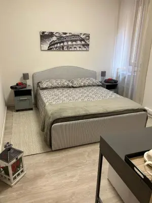 a bed in a room with a painting on the wall at Vatican Stay Ottaviano in Rome