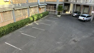 an empty parking lot in front of a building at Casa per Ferie Eden Cusmano in Rome