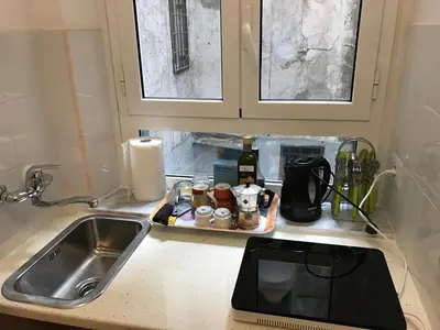 a kitchen counter with a sink and a microwave at Great studio near Coliseum in Rome
