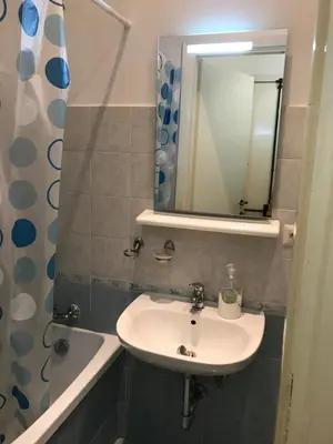 a bathroom with a sink and a mirror and a tub at Great studio near Coliseum in Rome